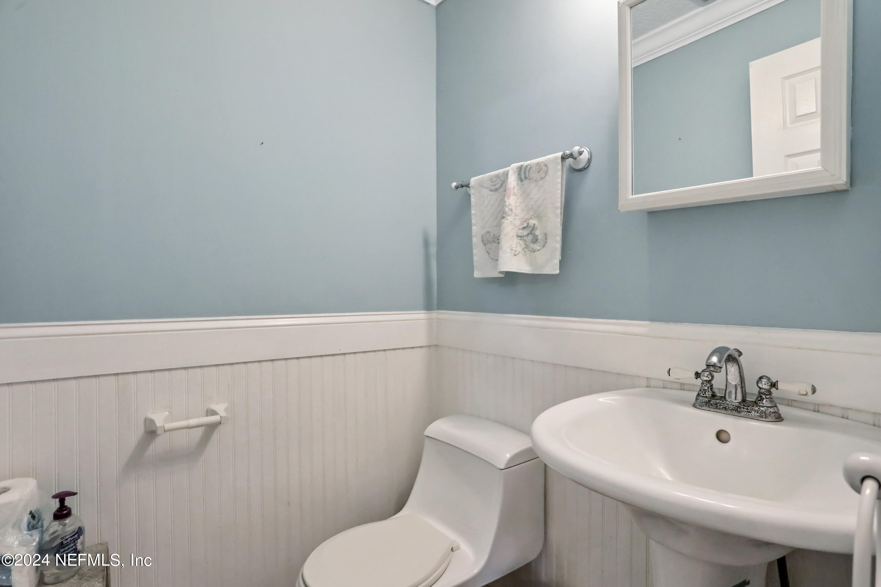 5321 Sweat Road Green Cove Springs, FL 32043 - Photo 16 of 31 a bathroom with a toilet sink and mirror