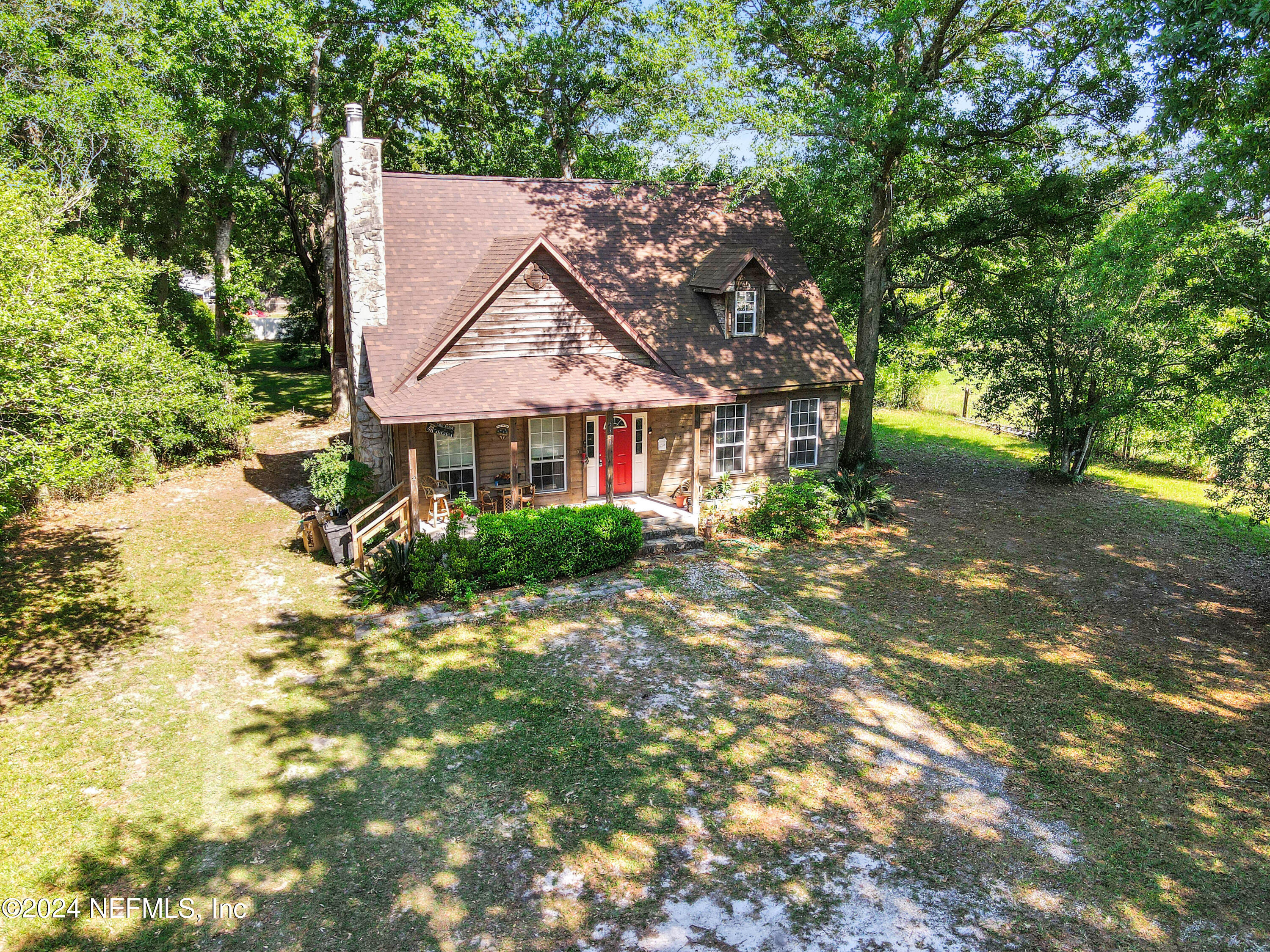 5321 Sweat Road Green Cove Springs, FL 32043 - Photo 8 of 31 a view of a house with a small yard and a tree