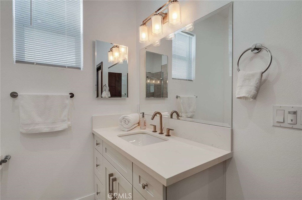 11837 Rideout Way Whittier, CA 90601 - Photo 31 of 44 a bathroom with a sink vanity and mirror