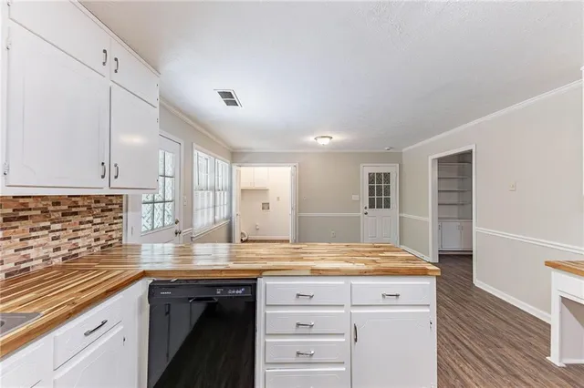 a kitchen with sink cabinets and stove
