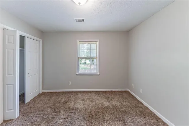 an empty room with a empty space and windows
