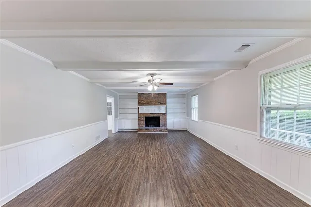 wooden floor in an empty room with a fireplace