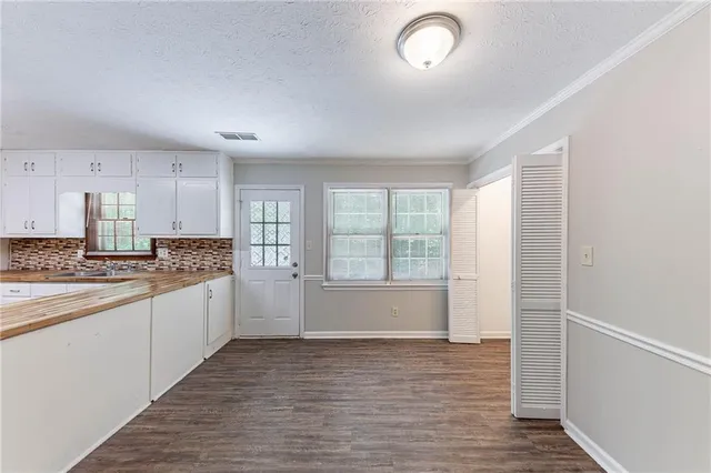 a large kitchen with kitchen island a sink stainless steel appliances and cabinets