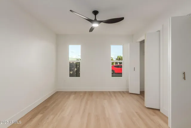 a view of empty room with wooden floor