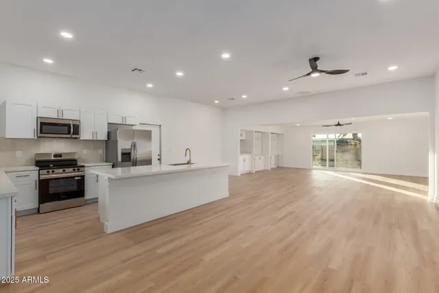 a kitchen with a sink stainless steel appliances and cabinets