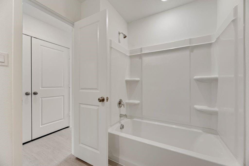 109 Pecan Flts Road Balch Springs, TX 75181 - Photo 5 of 26 a bathroom with a bathtub and a shower