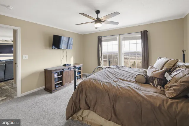 a bedroom with a bed and a television