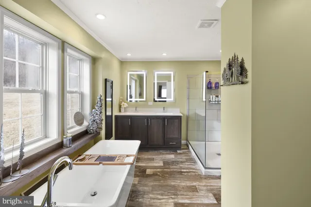 a bathroom with a tub sink and mirror
