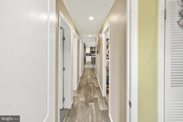 a view of a hallway with wooden floor