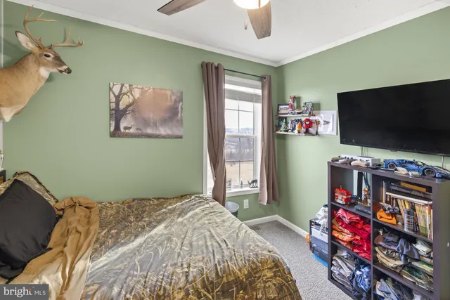 a bedroom with bed and a flat screen tv