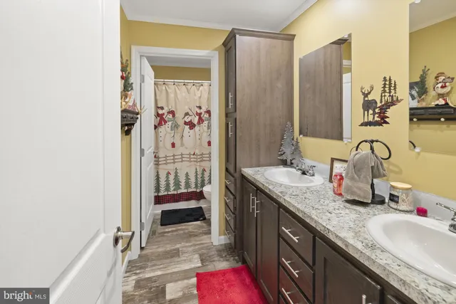 a bathroom with a granite countertop sink a mirror and a shower