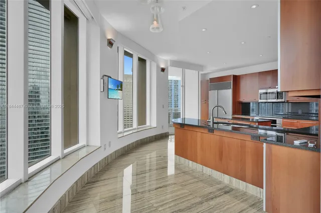 a kitchen with stainless steel appliances wooden floors and wooden cabinets
