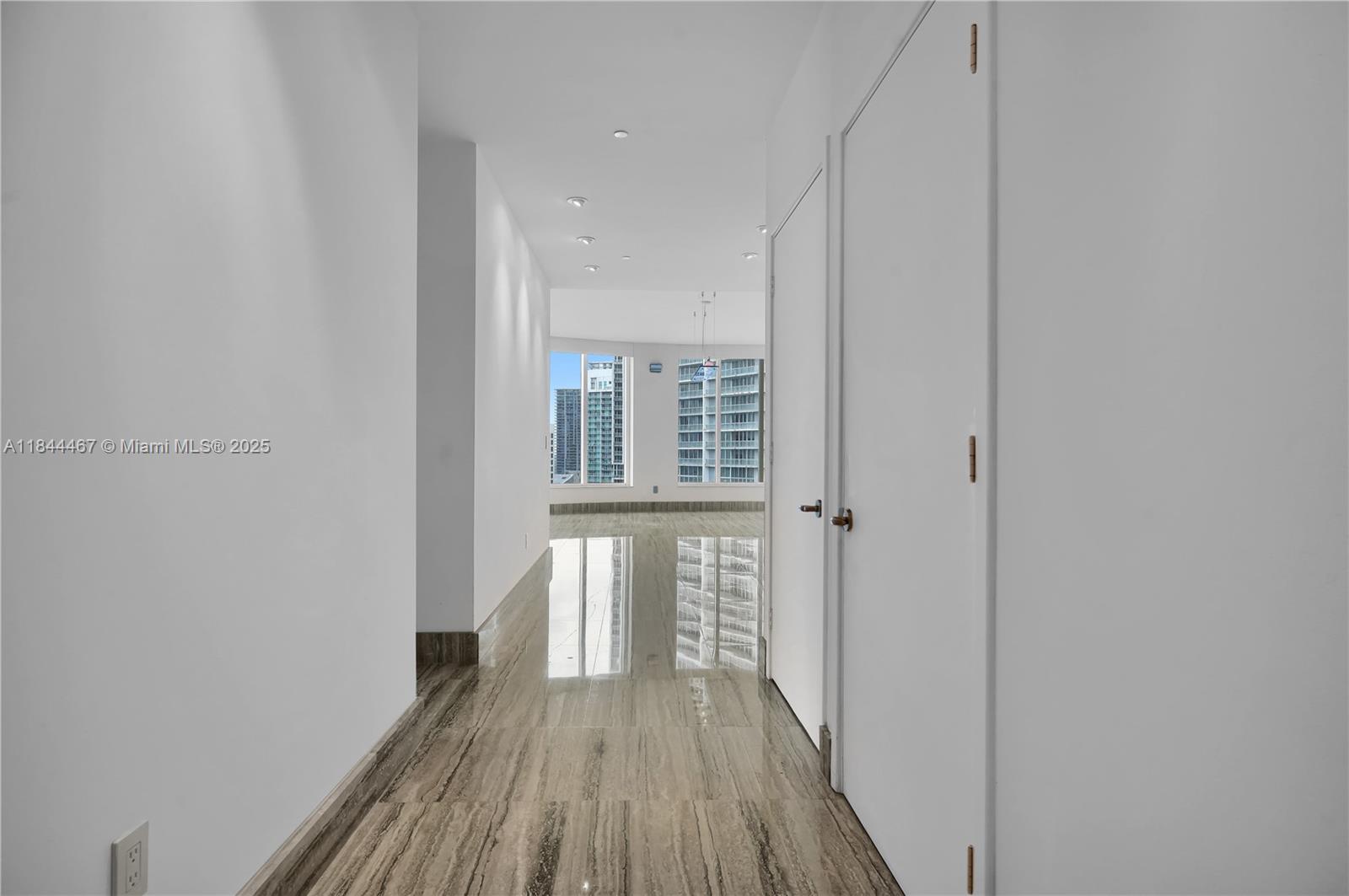 901 Brickell Key Boulevard, Unit 3204 Miami, FL 33131 - Photo 3 of 54 a view of a hallway with wooden floor