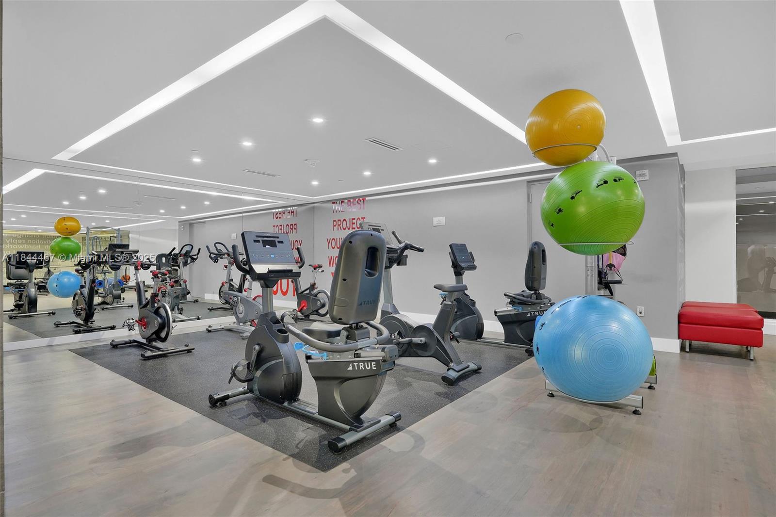 901 Brickell Key Boulevard, Unit 3204 Miami, FL 33131 - Photo 48 of 54 a room with gym equipment and mirrors