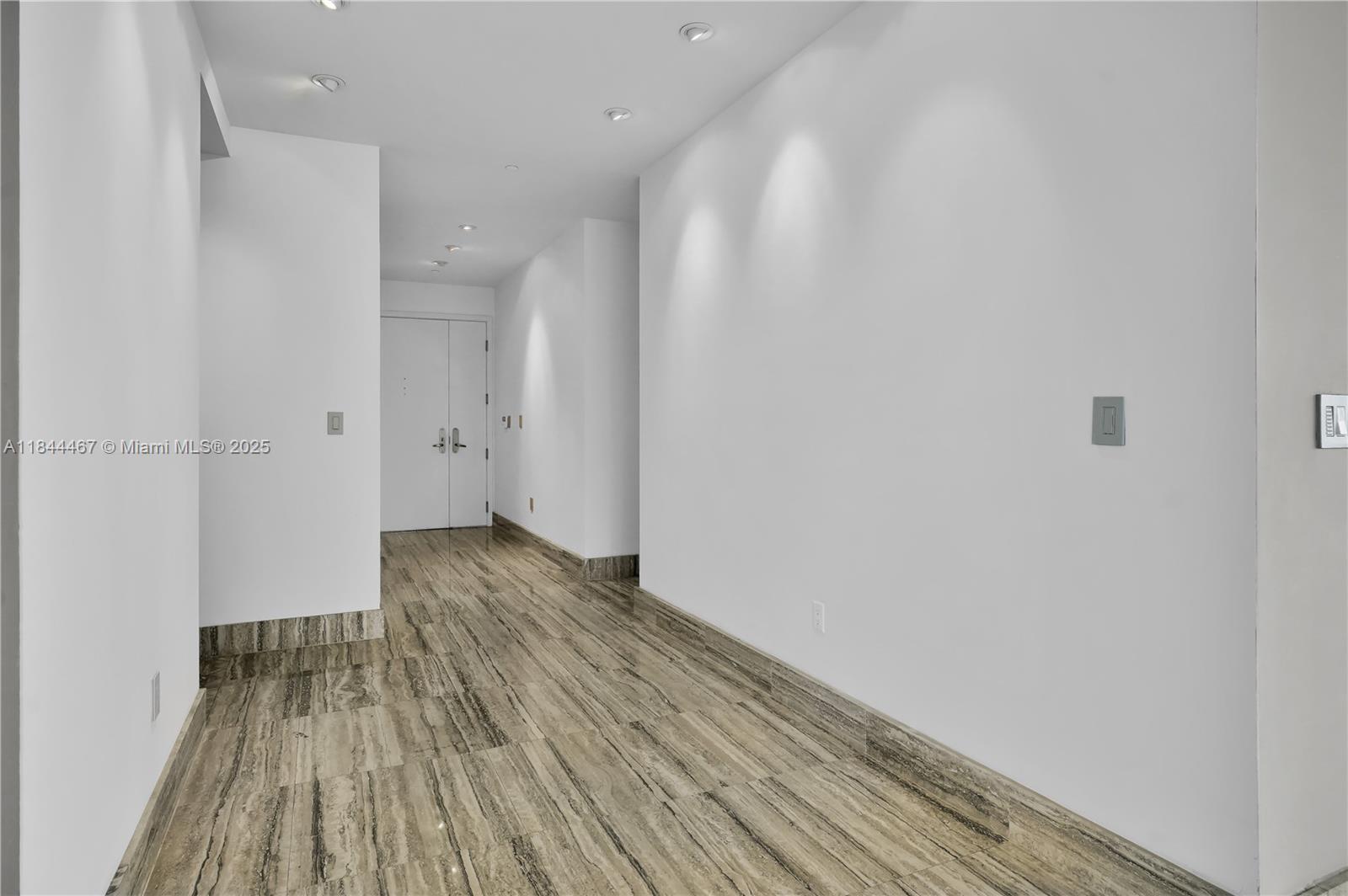901 Brickell Key Boulevard, Unit 3204 Miami, FL 33131 - Photo 7 of 54 a view of a room with wooden floor and a ceiling fan