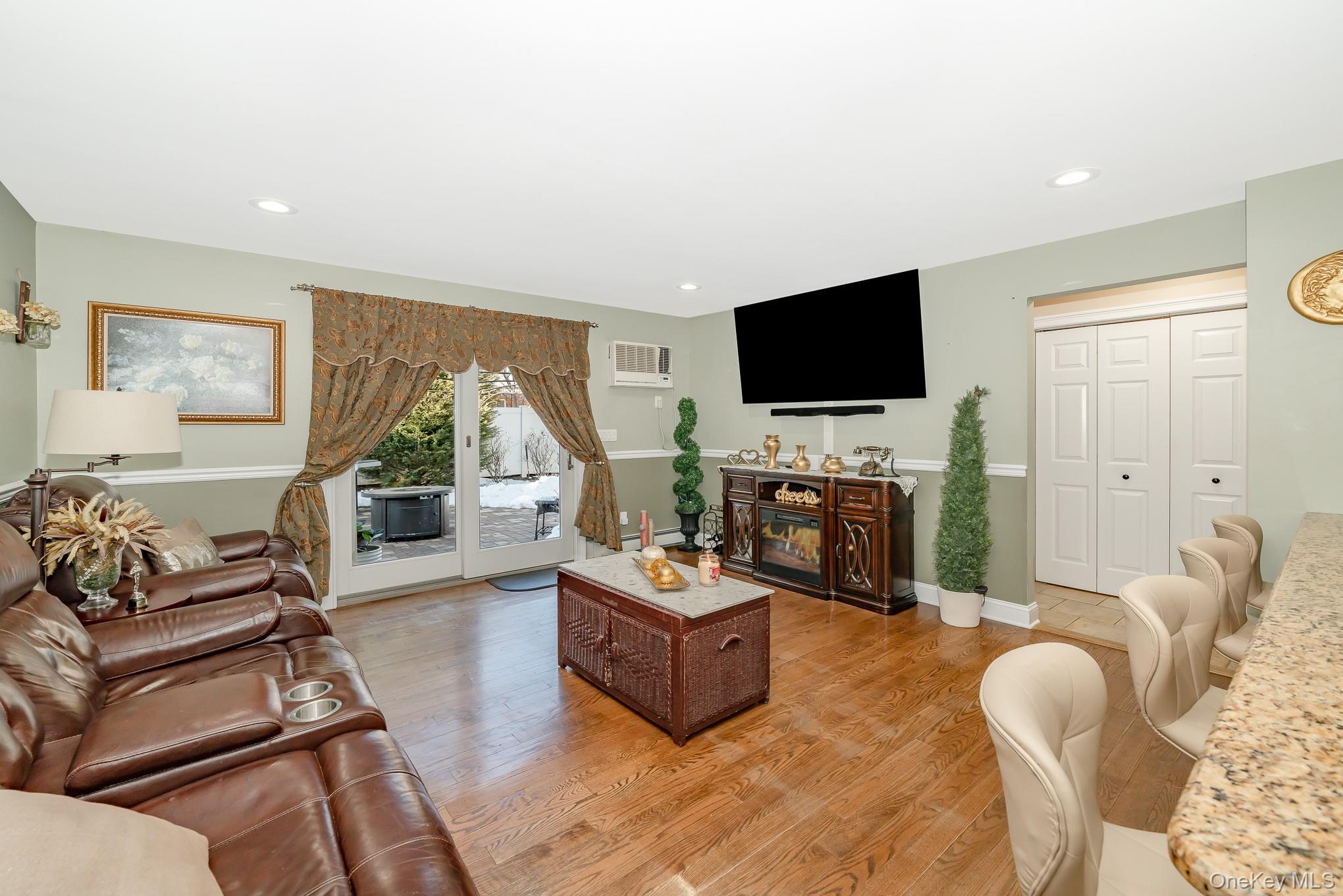 25 Old Mill Road Merrick, NY 11566 - Photo 4 of 19 Den w/ Andersersen Sliders to Patio