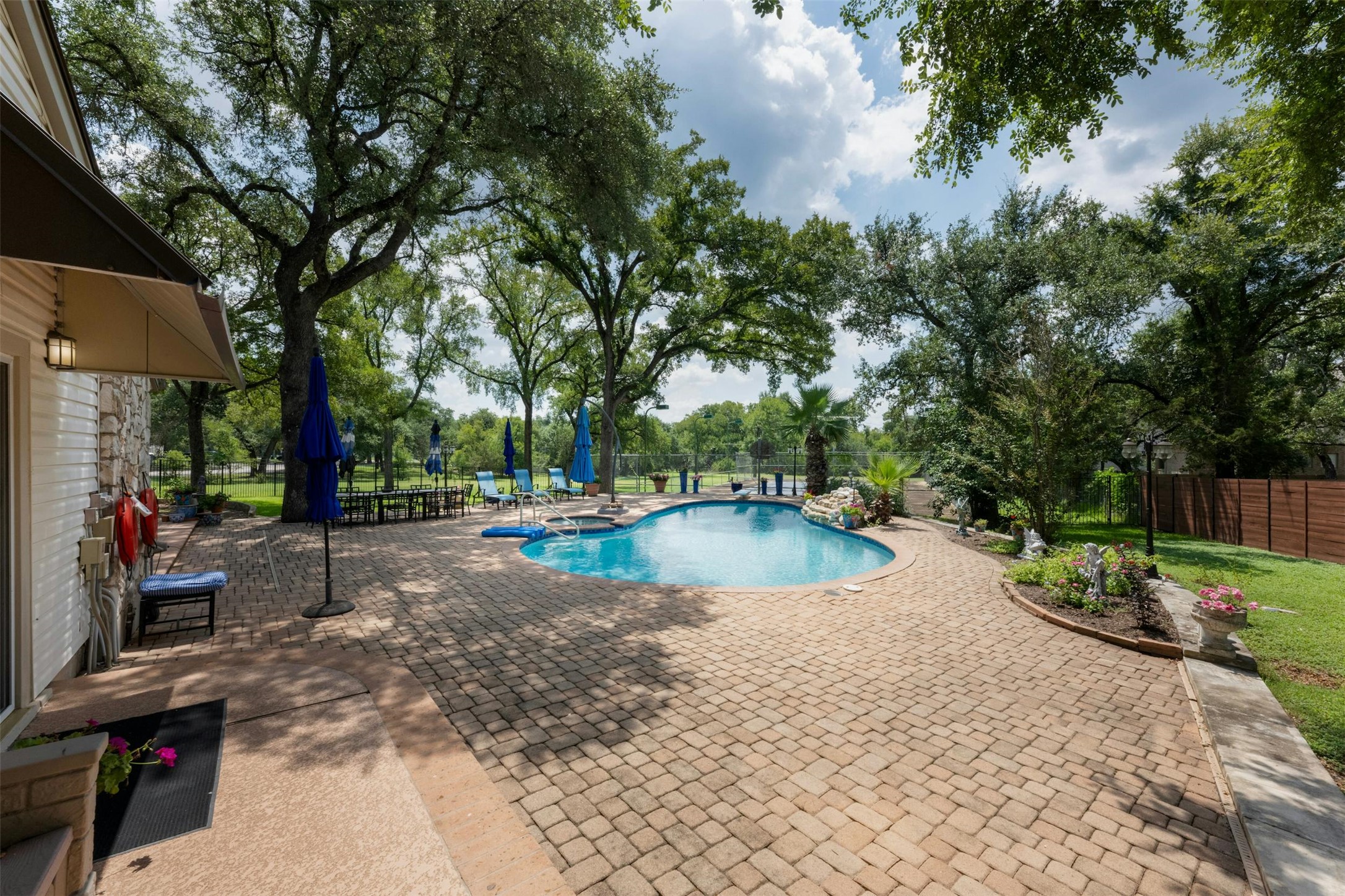9911 Anderson Mill Road Austin, TX 78750 - Photo 23 of 29 An inviting pool area surrounded by mature trees offers a private oasis with ample space for relaxation.