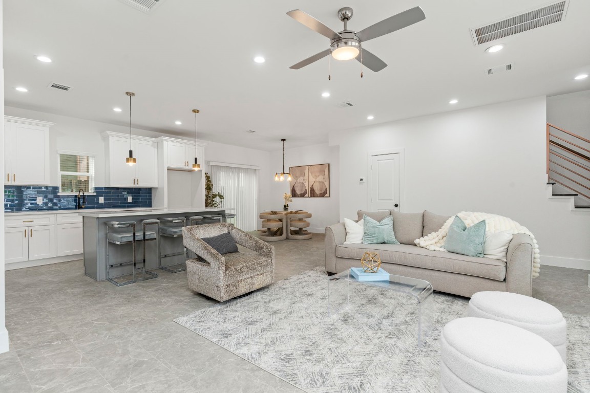 a living room with furniture and kitchen view