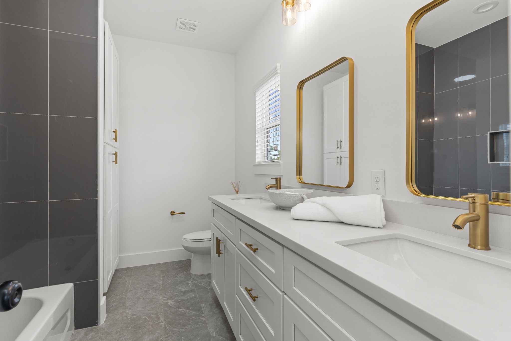 1517 Egypt Street Houston, TX 77009 - Photo 36 of 46 a bathroom with a double vanity sink toilet and mirror