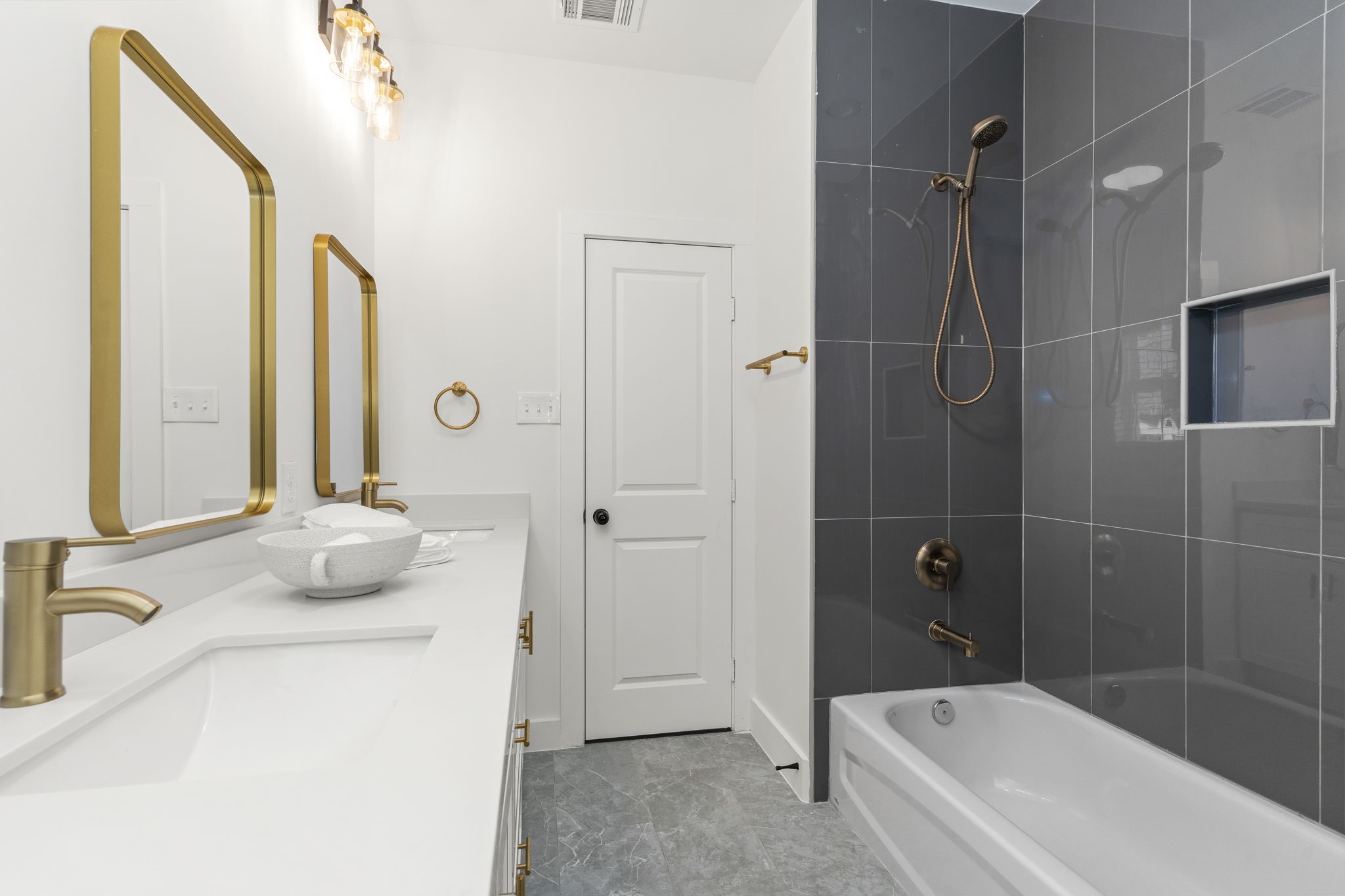 1517 Egypt Street Houston, TX 77009 - Photo 37 of 46 a bathroom with a granite countertop sink a mirror and a bathtub