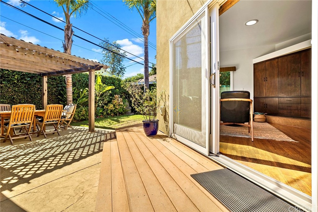 831 Appleby Street Venice, CA 90291 - Photo 28 of 39 a view of a patio with dining table and chairs under an umbrella with a barbeque
