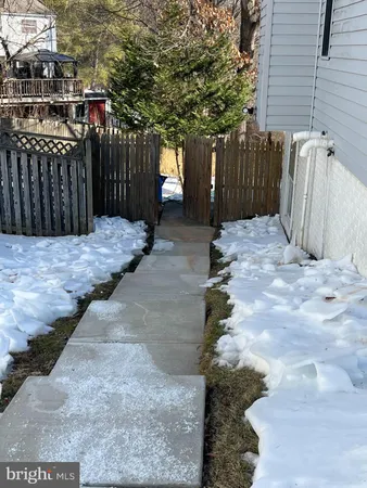 a view of a backyard with wooden fence