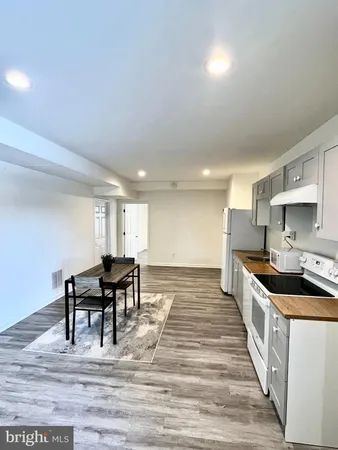 a kitchen with kitchen island granite countertop a sink and counter space