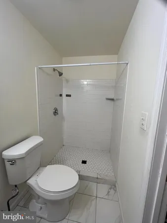 a bathroom with a toilet and a shower