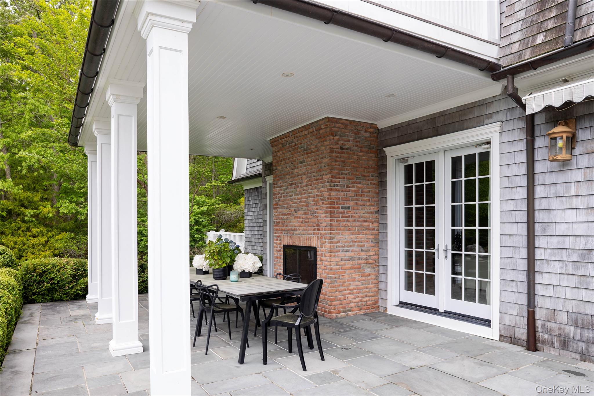 486 Middle Line Highway Bridgehampton, NY 11976 - Photo 23 of 25 a view of a patio with table and chairs and potted plants