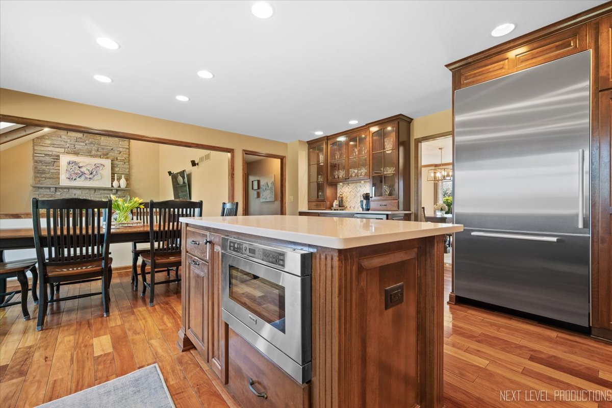 87 Hawkins Circle Wheaton, IL 60189 - Photo 12 of 42 a kitchen with stainless steel appliances granite countertop a table chairs and a refrigerator