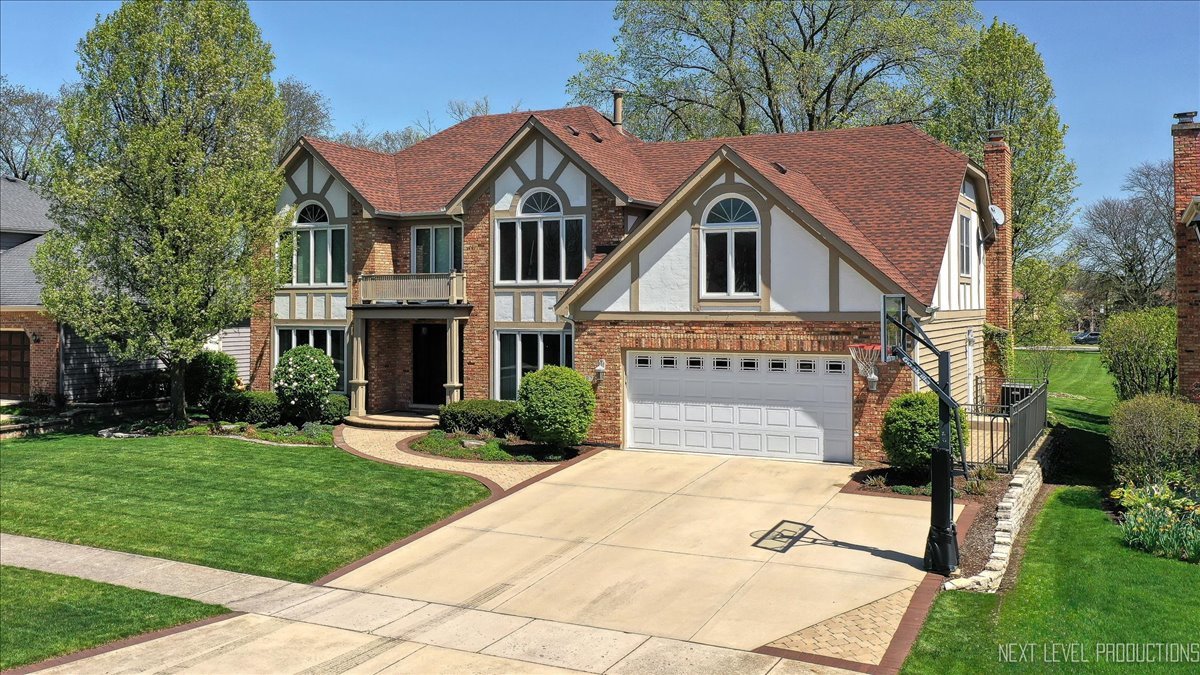 87 Hawkins Circle Wheaton, IL 60189 - Photo 2 of 42 a front view of a house with a yard