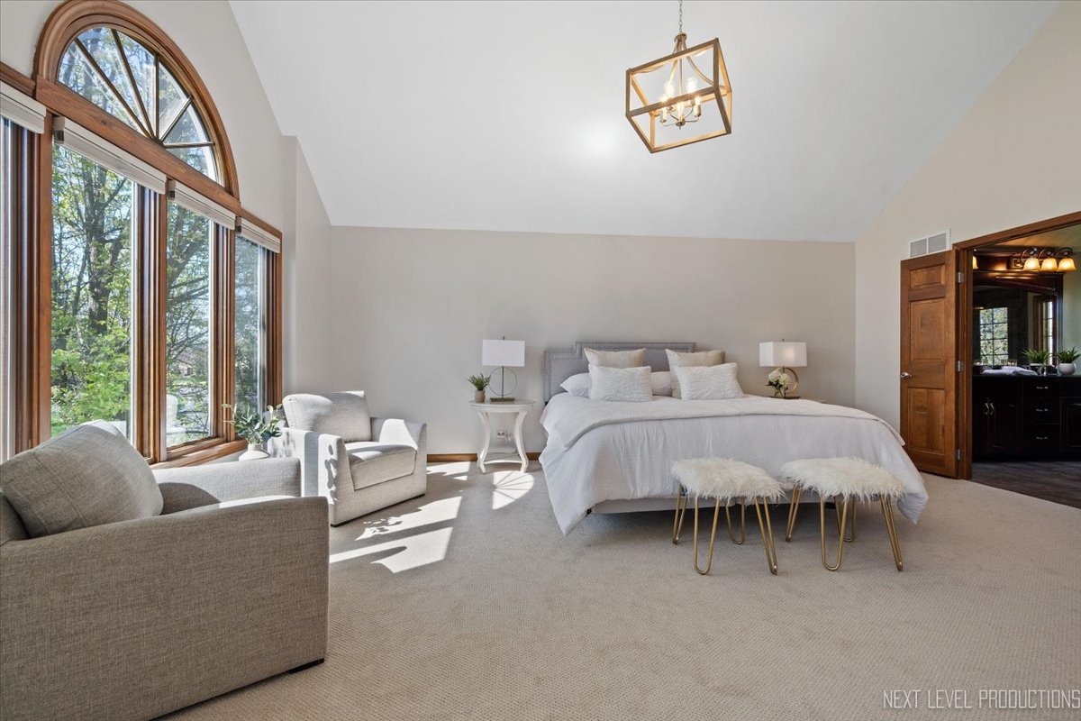 87 Hawkins Circle Wheaton, IL 60189 - Photo 21 of 42 a bedroom with a bed and a chandelier