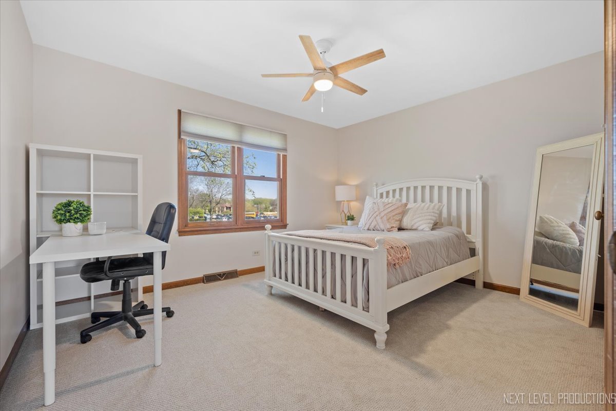87 Hawkins Circle Wheaton, IL 60189 - Photo 24 of 42 a bedroom with a bed and a desk