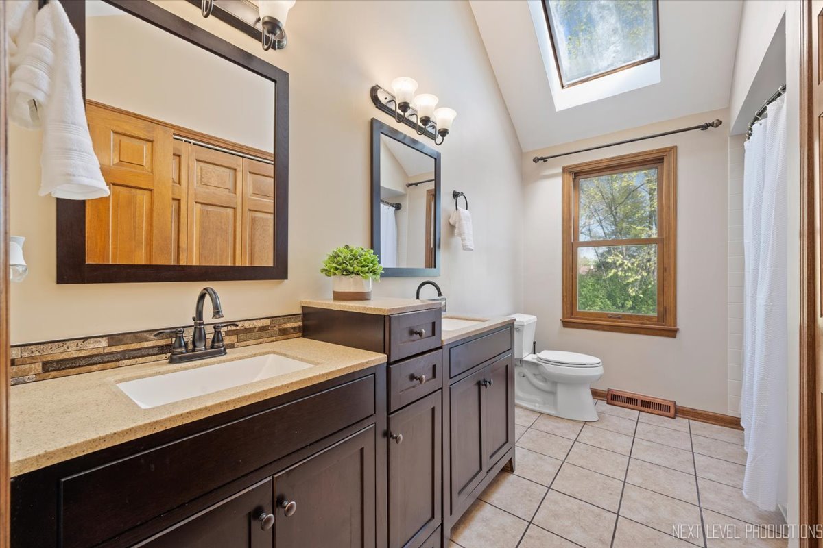 87 Hawkins Circle Wheaton, IL 60189 - Photo 26 of 42 a bathroom with a sink a toilet and a mirror