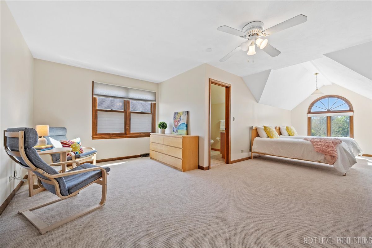 87 Hawkins Circle Wheaton, IL 60189 - Photo 27 of 42 a bedroom with furniture and a chandelier