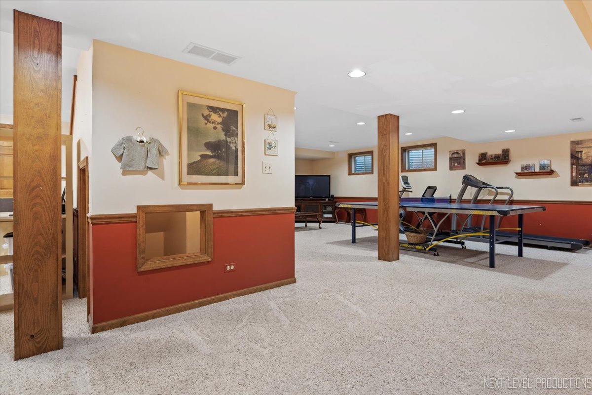 87 Hawkins Circle Wheaton, IL 60189 - Photo 31 of 42 a living room with furniture and a table