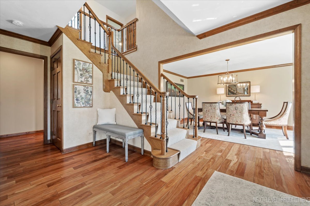 87 Hawkins Circle Wheaton, IL 60189 - Photo 4 of 42 a view of entryway dining room and hall with wooden floor