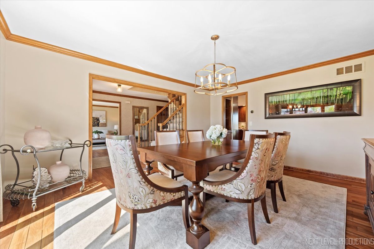 87 Hawkins Circle Wheaton, IL 60189 - Photo 6 of 42 a view of a dining room with furniture a chandelier and wooden floor