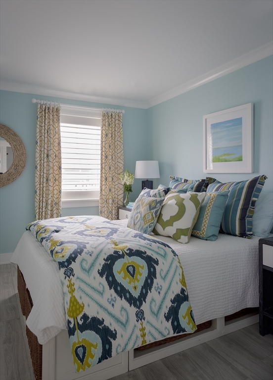 353 Beach Avenue Hull, MA 02045 - Photo 19 of 30 a bed sitting in a bedroom next to a window