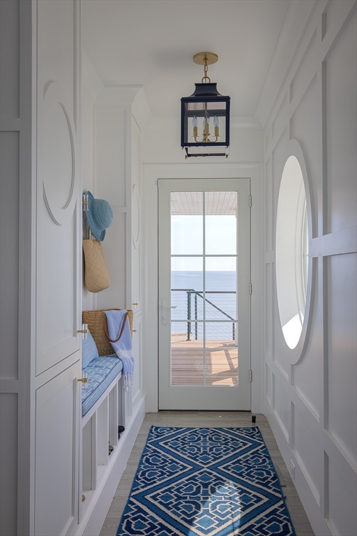 353 Beach Avenue Hull, MA 02045 - Photo 2 of 30 a view of a hallway with wooden floor and a living room