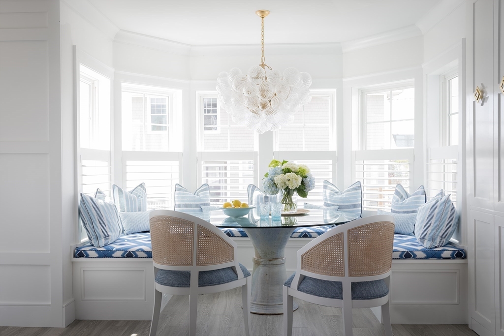 353 Beach Avenue Hull, MA 02045 - Photo 8 of 30 a dining room with furniture a chandelier and wooden floor