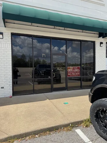 a living room with a rug and a floor to ceiling window