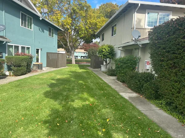 a front view of a house with garden and yard