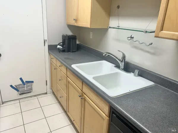 a kitchen with a sink cabinets and appliances