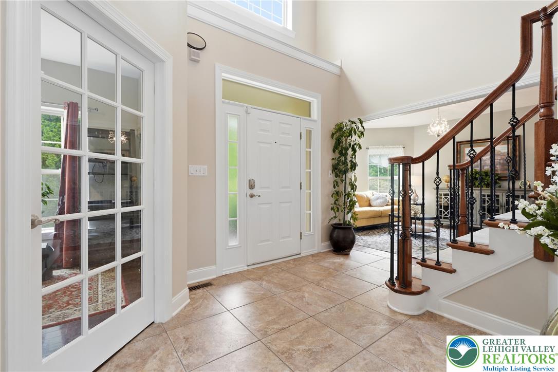 245 East Dell Road Bath, PA 18014 - Photo 5 of 99 Elegant foyer with soaring ceilings, a grand staircase, and gleaming tile floors welcomes guests.
