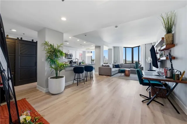 a view of a dining room with furniture and a potted plant