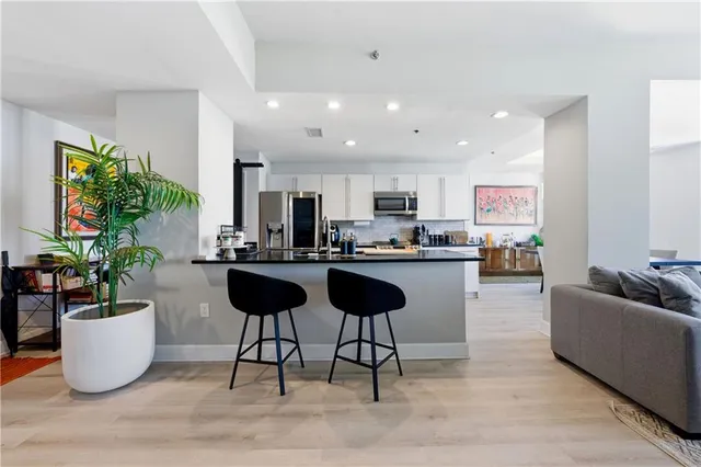 a living room with furniture and a potted plant