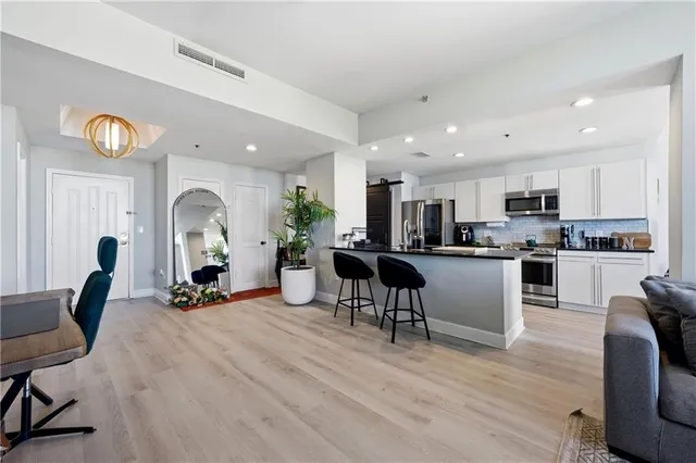 a view of kitchen with dining room wooden floor and living room