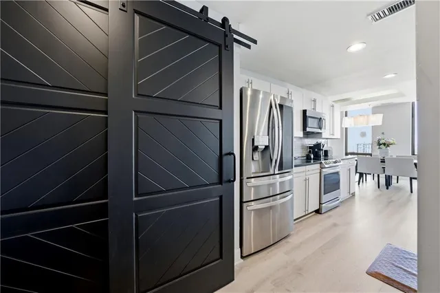 a kitchen with cabinets and stainless steel appliances