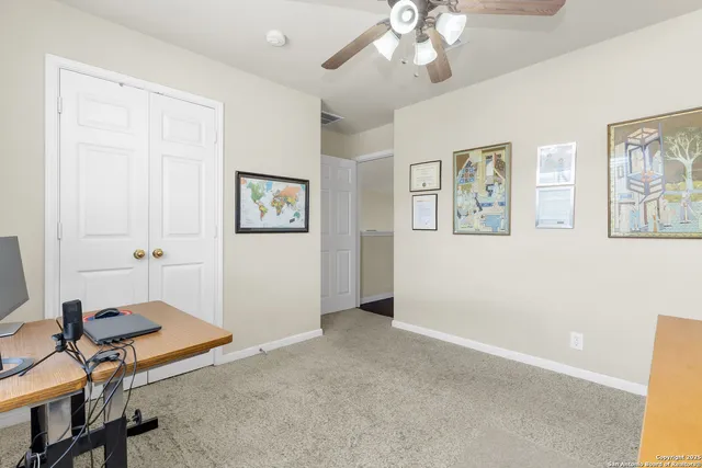 a view of a livingroom with workspace and a window